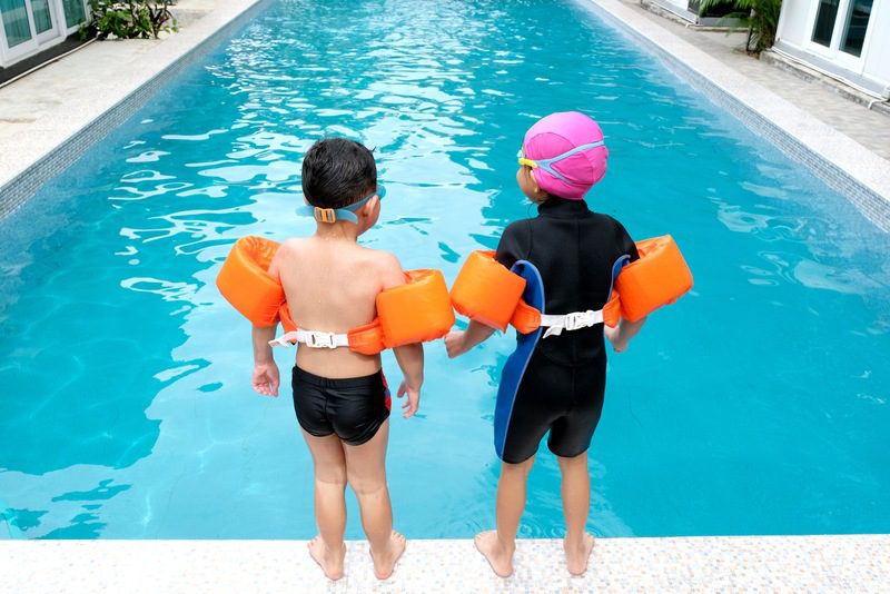 Children Learning Water Safety Skills Swimming instructor teaching water safety skills to children in Canadian swimming program