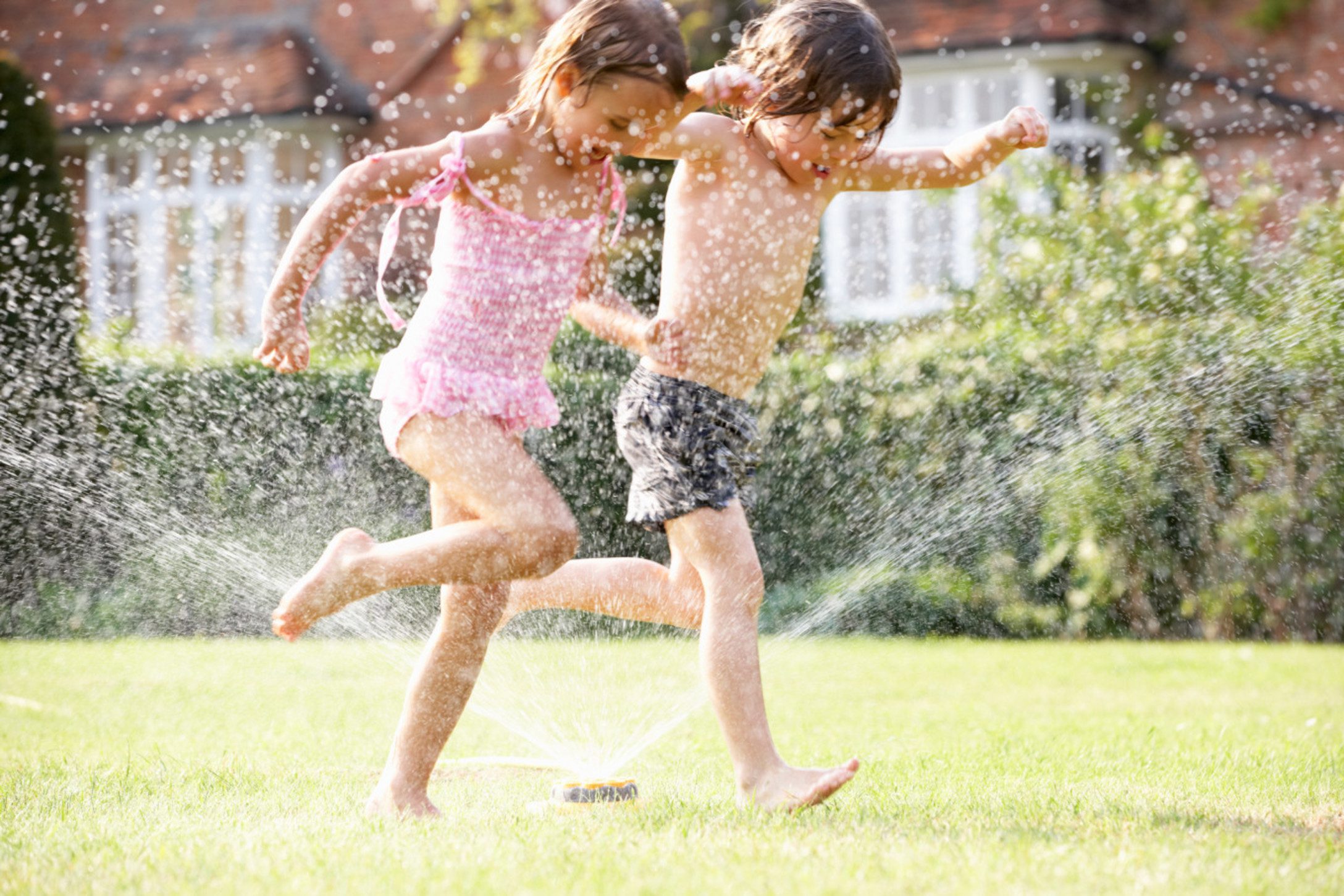 Summer safety tips for Canadian families Parents applying sunscreen and safety gear for summer outdoor activities with children