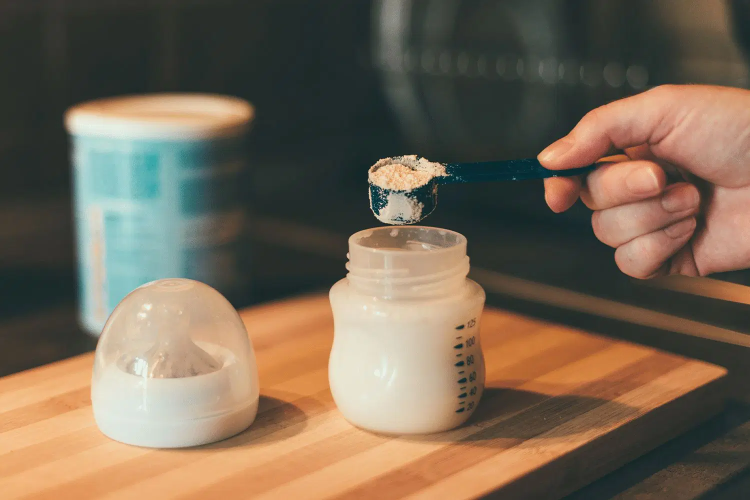 Safe Baby Formula Feeding in Canada Parent feeding baby with formula bottle showing safe feeding practices for Canadian infants