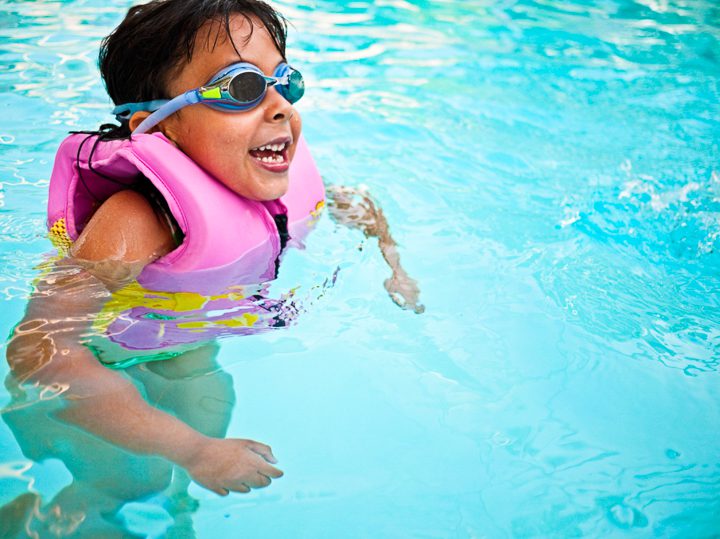 Children Learning Water Safety Skills Swimming instructor teaching water safety skills to children in Canadian swimming program