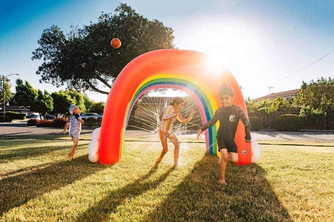 Summer beach activities for Canadian families Family enjoying outdoor summer fun activities at beach with children building sandcastles