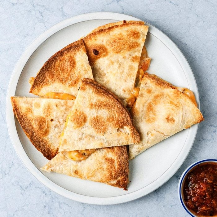 Easy quesadilla lunch idea for kids Delicious air fryer quesadilla cut into triangles for kids lunch