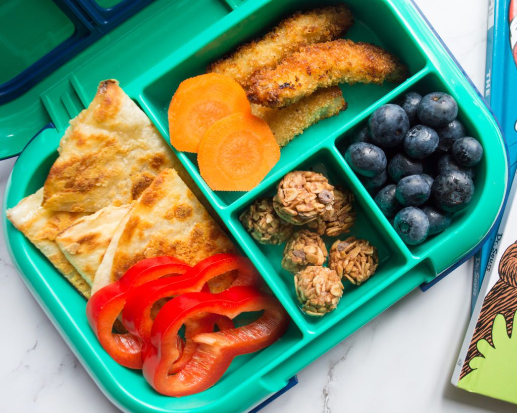 Organized bento box lunch for children Bento box style lunch with compartments filled with kid-friendly foods for picky eaters