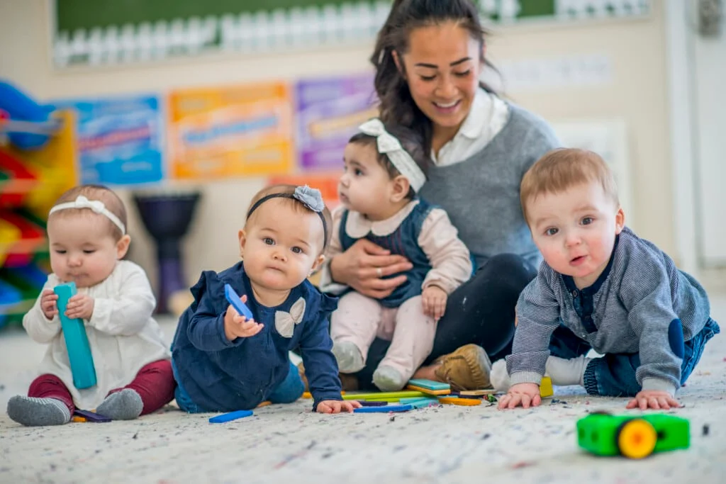 Professional daycare supervision and care in Canada Toddlers with caregiver in Canadian daycare setting showing proper supervision
