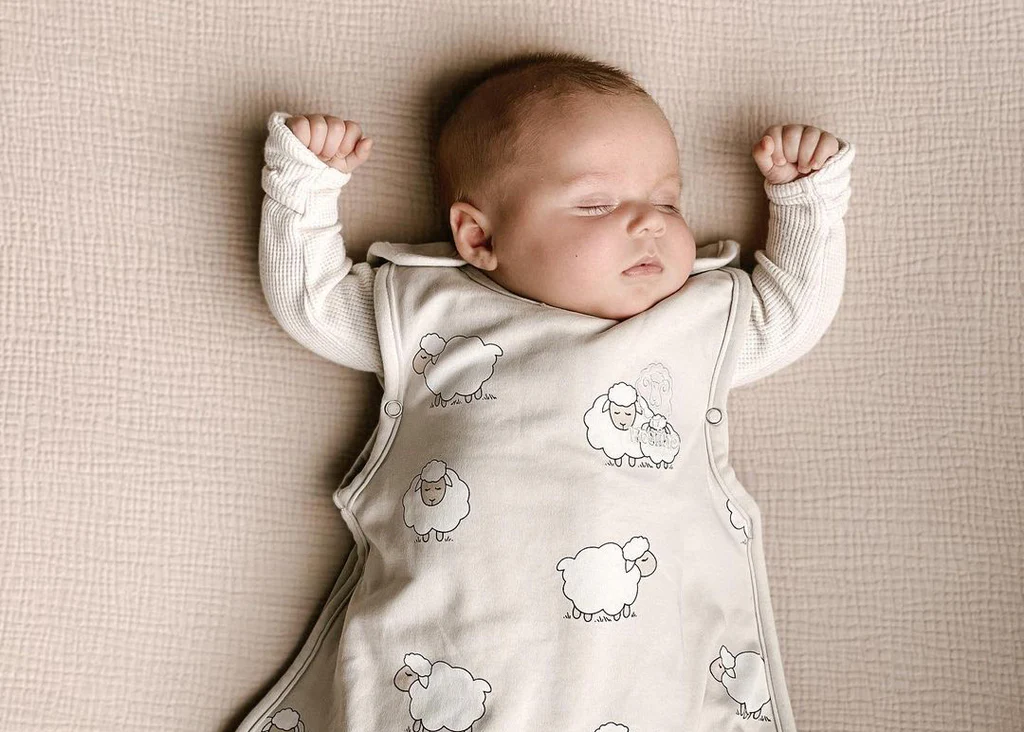 Proper sleep sack use for safe baby sleep year-round Baby sleeping in Woolino 4 season sleep sack showing proper safe sleep positioning