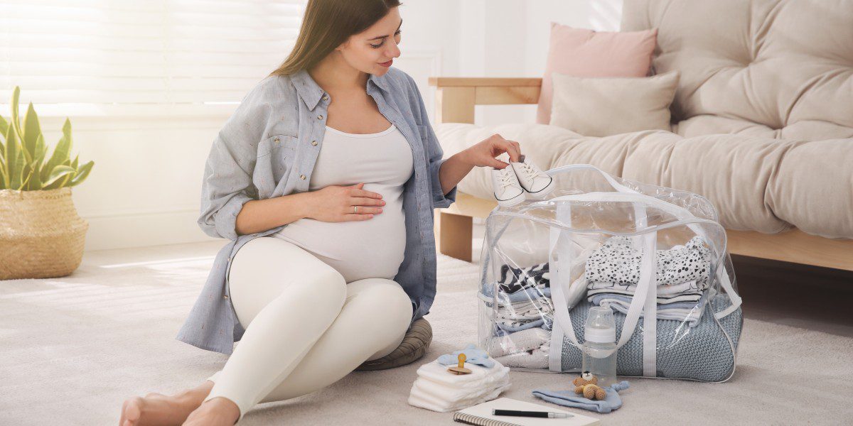 Preparing for maternity leave in Canada - budgeting and hospital preparation Canadian pregnant woman preparing maternity leave budget and packing hospital bag for fall delivery