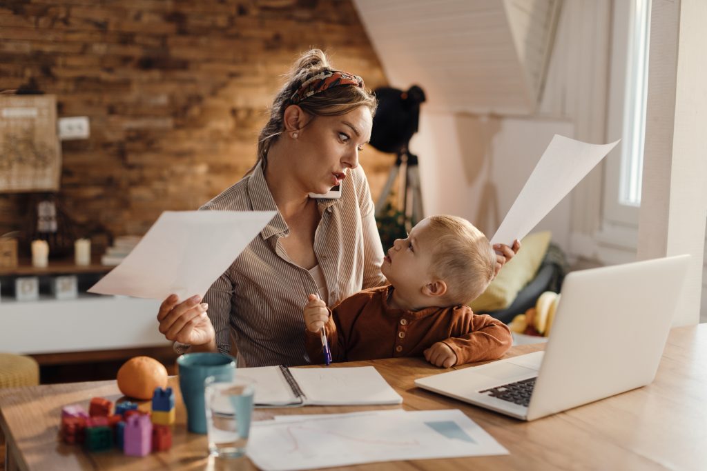 Single parent budgeting strategies - managing finances while working from home in Canada Canadian single mother managing family budget while working from home with child