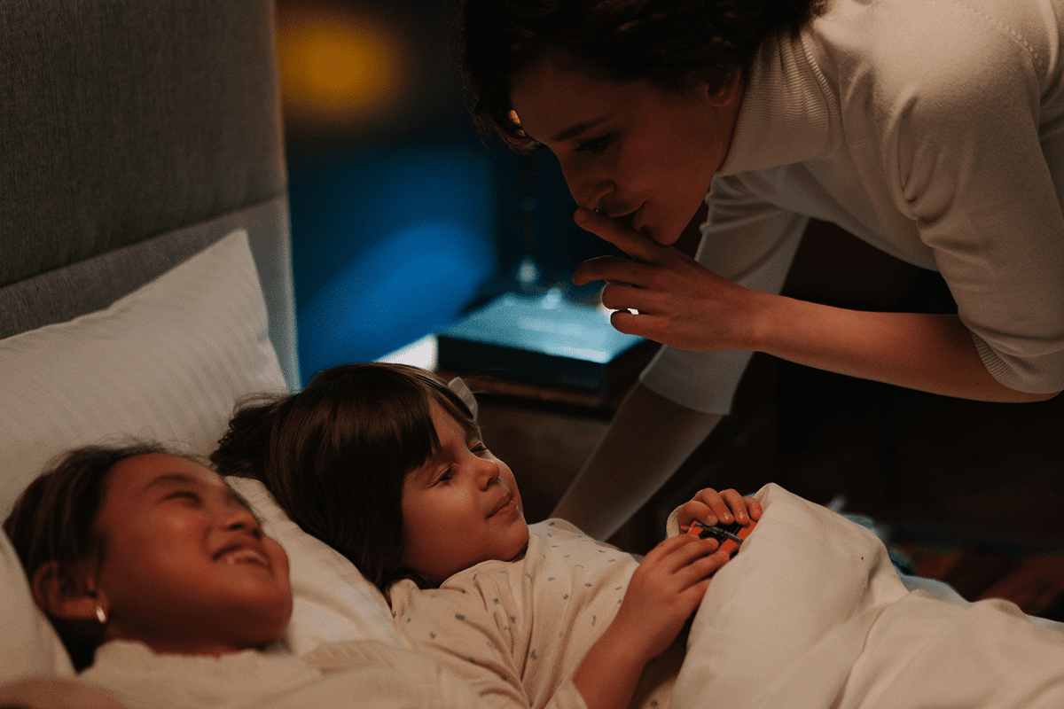 Bedtime routine for Canadian school-age children with family support Canadian family bedtime routine with children preparing for sleep and parents providing guidance