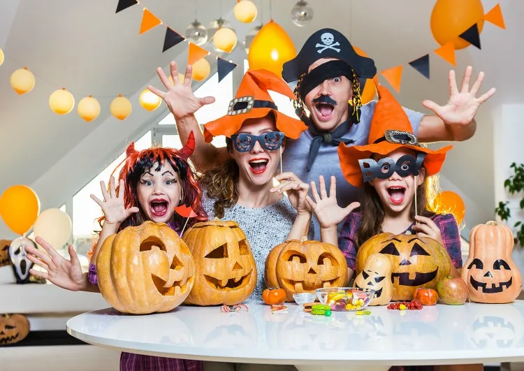 Family carving pumpkins and enjoying classic Halloween traditions together