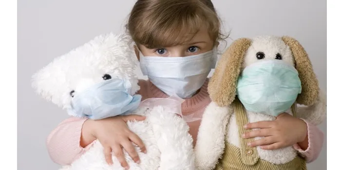Young girl sneezing into a tissue to prevent spreading germs