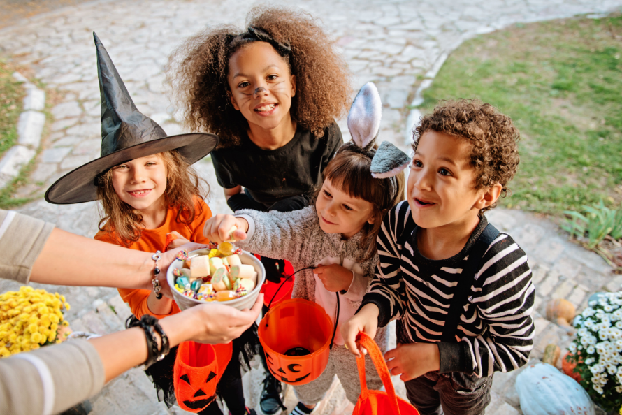 Family celebrating Halloween with costumes and Switch Witch surprises
