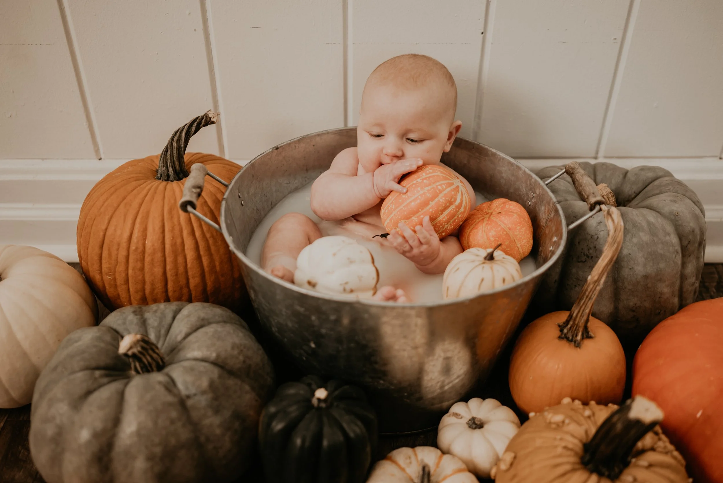 Parents organizing fall baby registry gifts in a cozy living room
