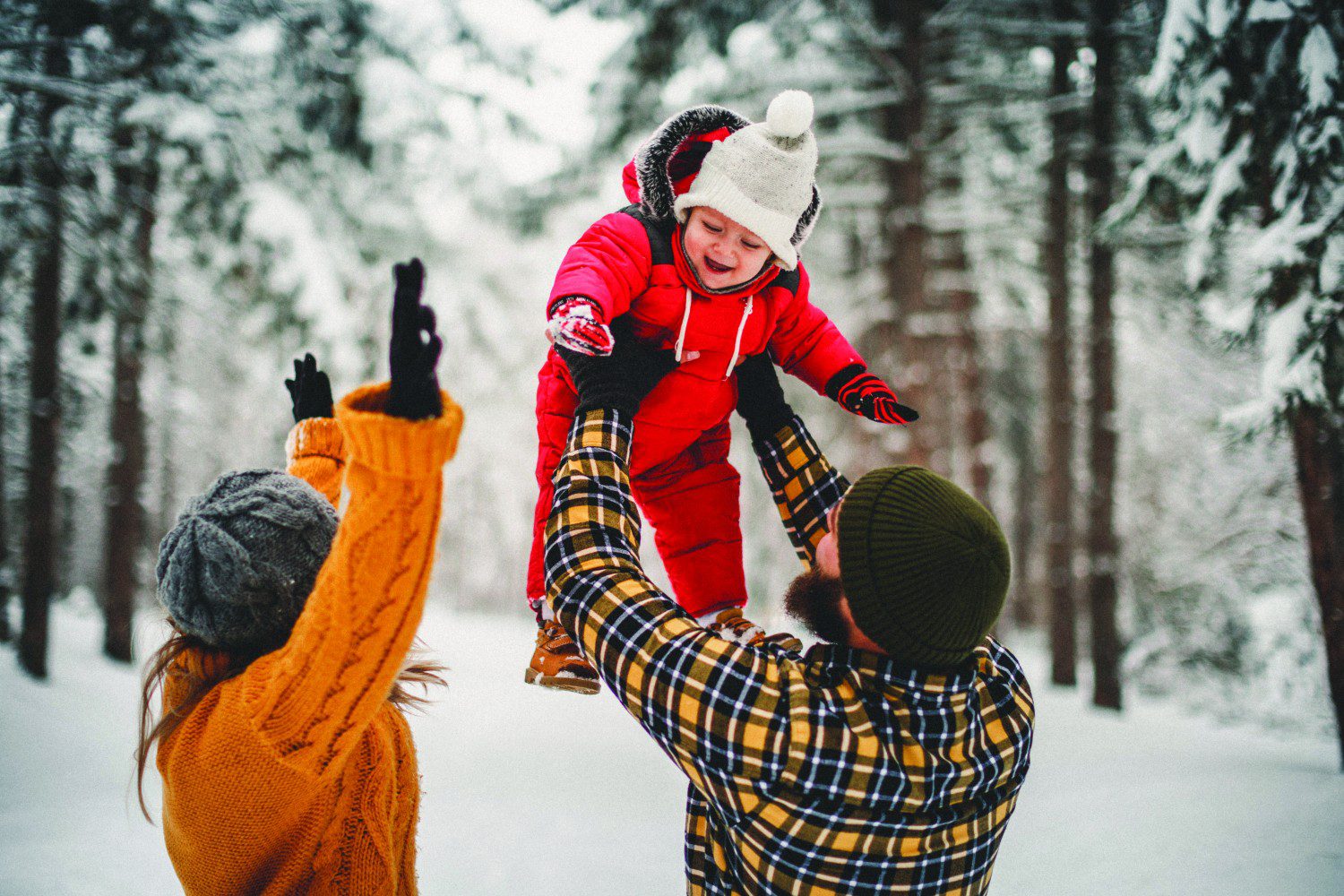 Baby bundled in a stroller footmuff on a snowy Canadian sidewalk