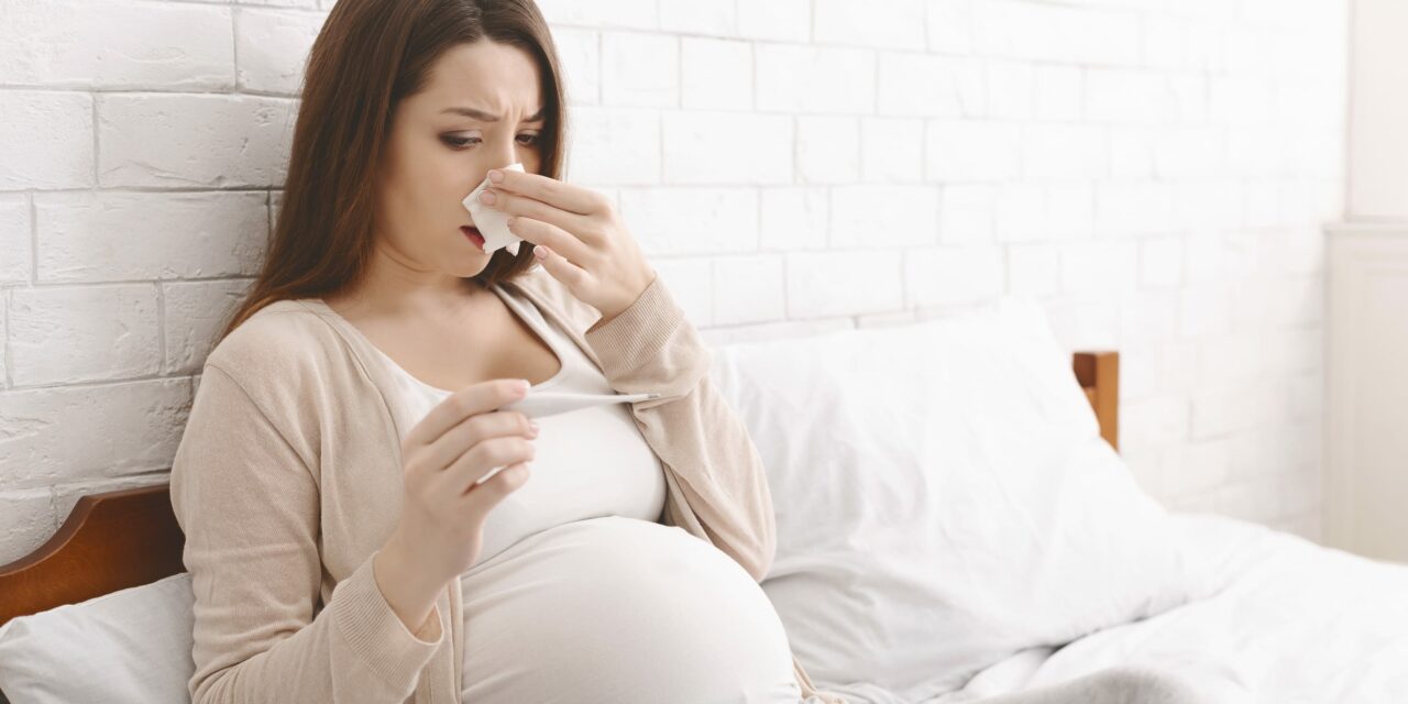 Pregnant Canadian taking winter illness prevention steps—rest, hydration, and masking when needed