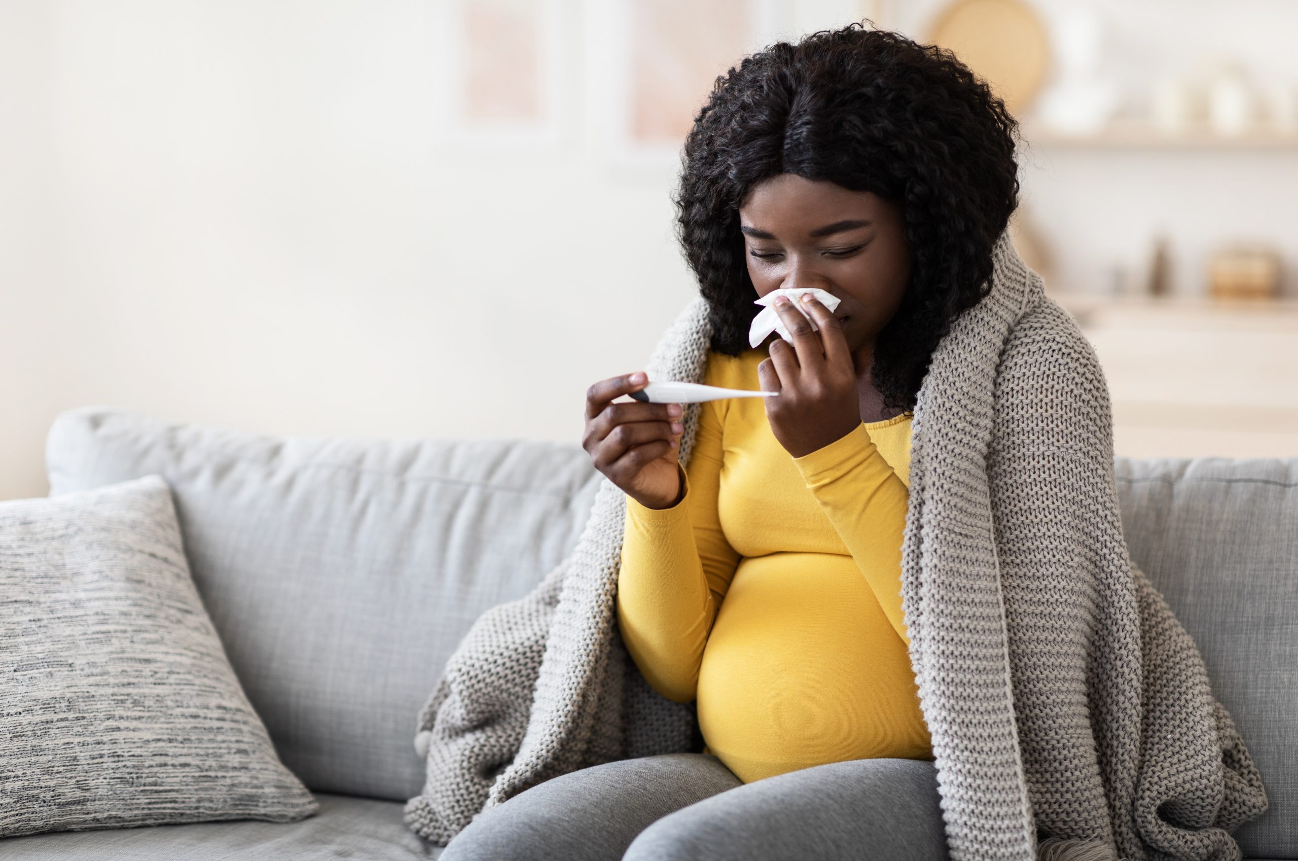 Pregnant person in Canada resting at home and following care advice for flu‑like illness