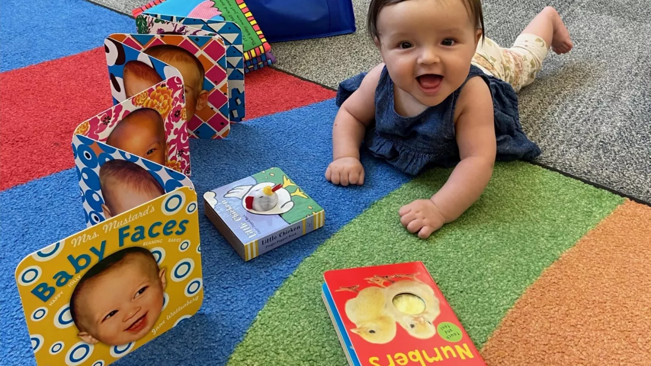 Baby enjoying books at library storytime program in Canada