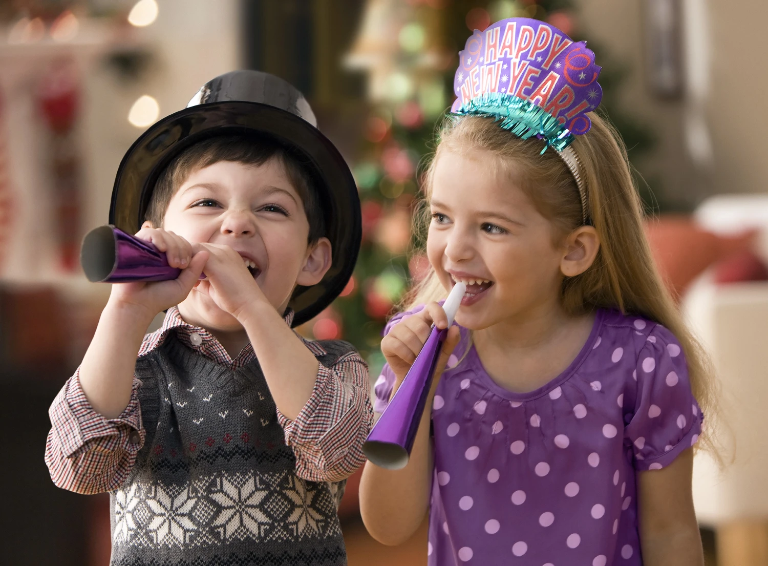 Kids celebrating New Year's Eve party with festive decorations