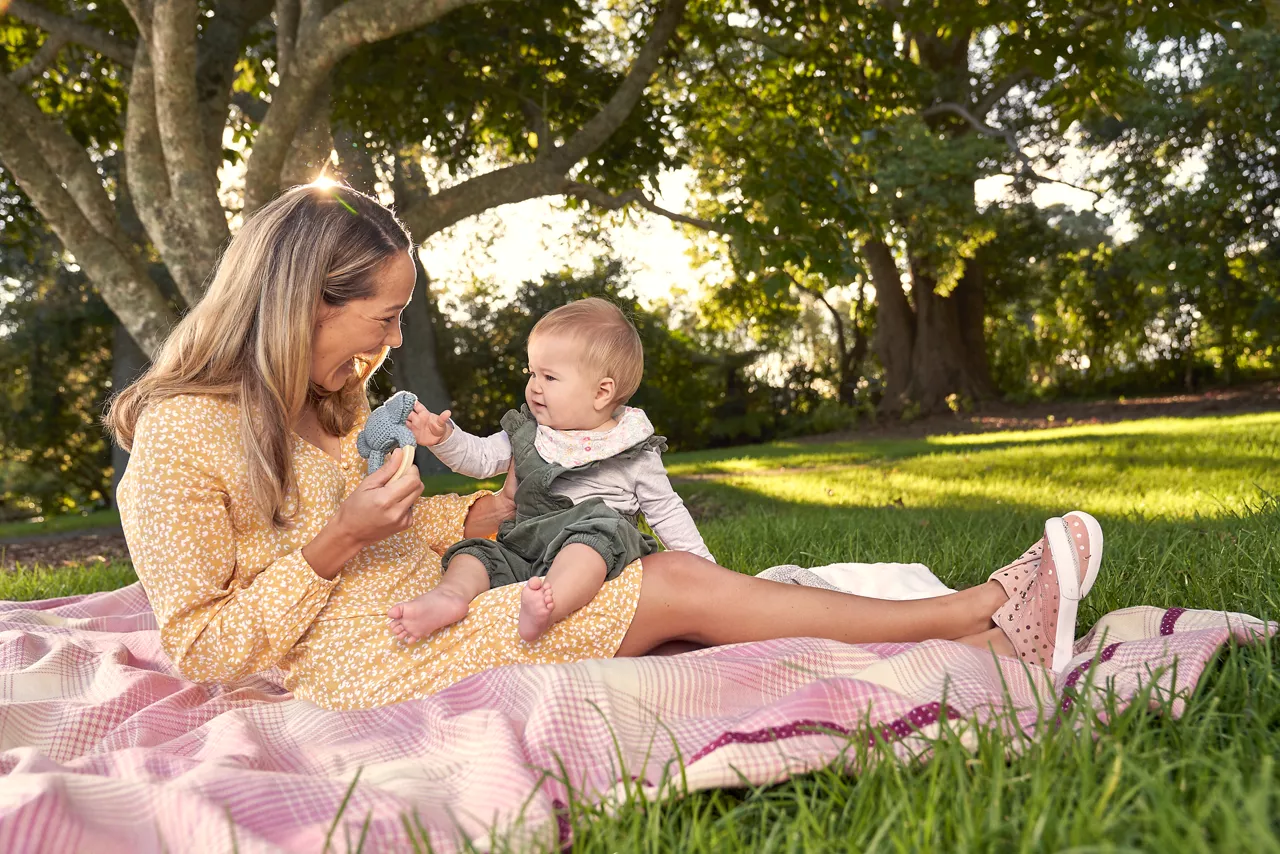 Parent spending calm outdoor time with a baby during the middle of the day